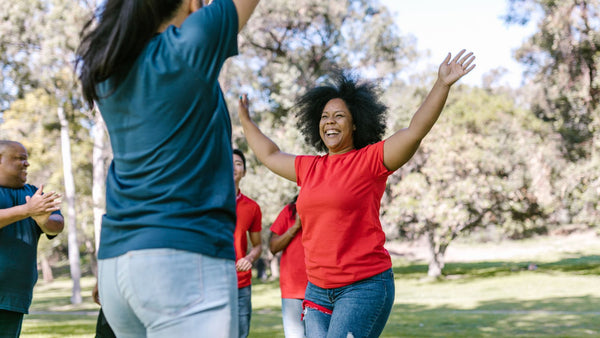 happy women working out doing star jumps