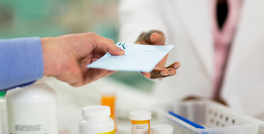 Prescription being handed over counter