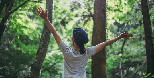 Women celebrating organic nature in the woods