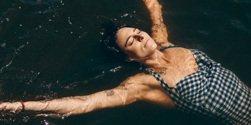 Relaxed middle-aged woman swimming