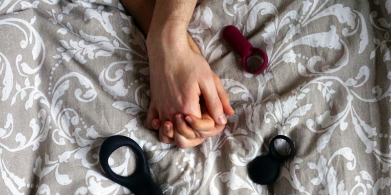 couple in bed with natural sex toys
